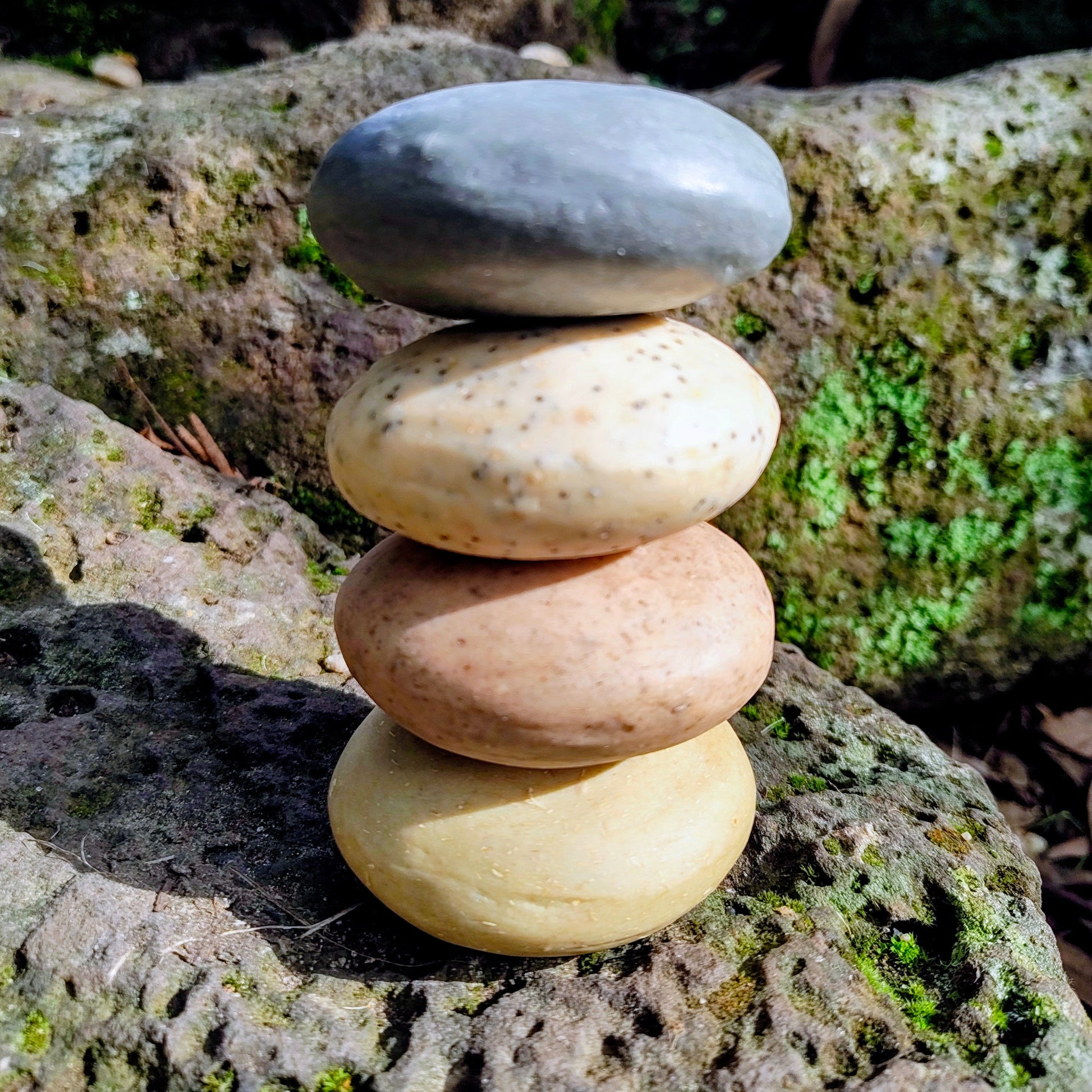 A stack of four Elementary Wash Rocks in a natural stone setting